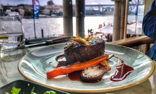The steak at Q Dining with Sydney Harbour view in the background